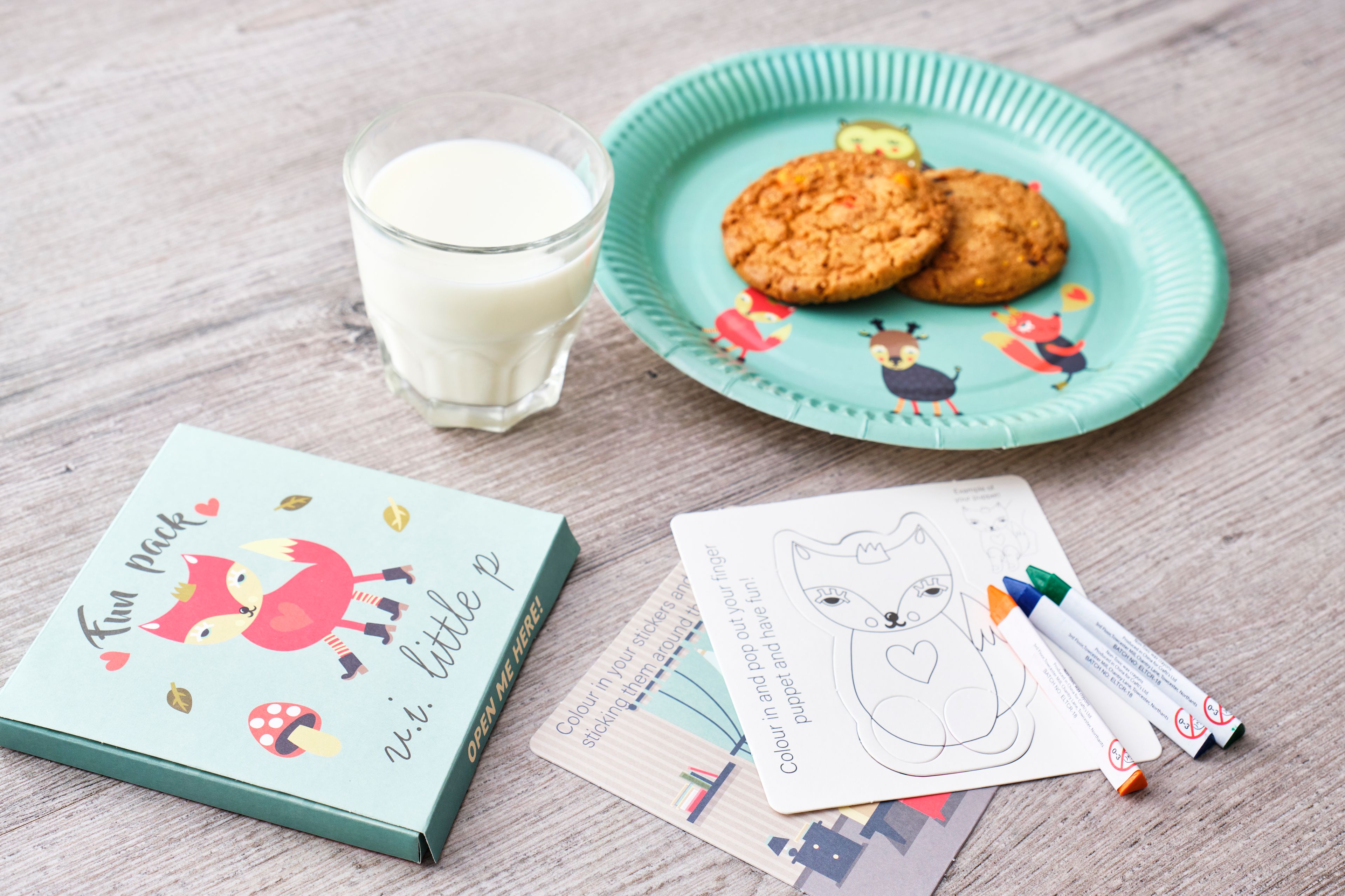 Milk and cookies with a child's colouring set