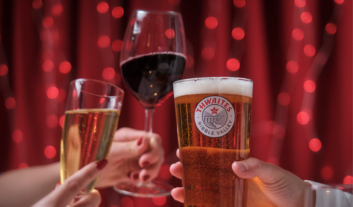 Pint, red wine & prosecco in front of sparkly background