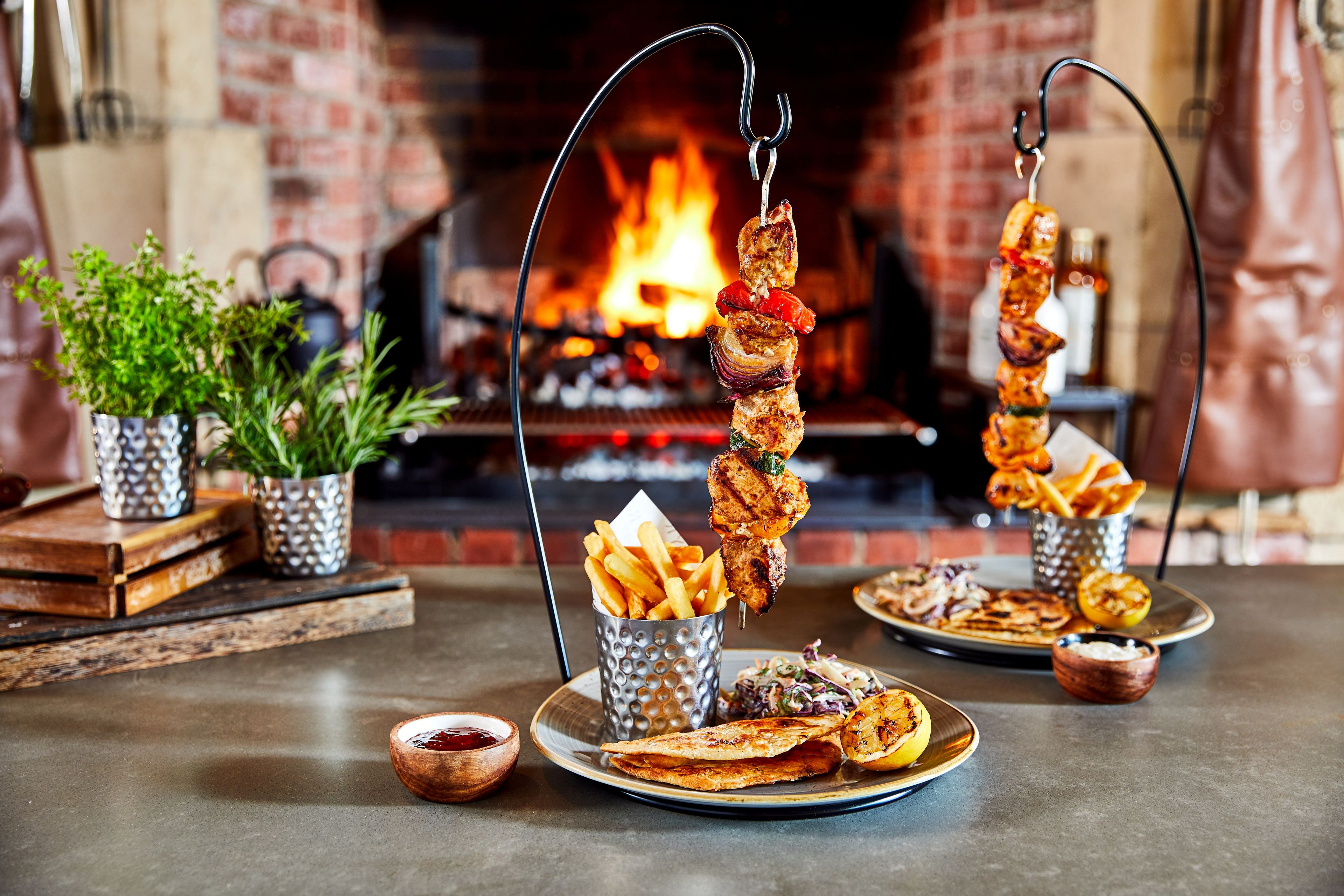 Hanging kebabs in front of open FYR Grill